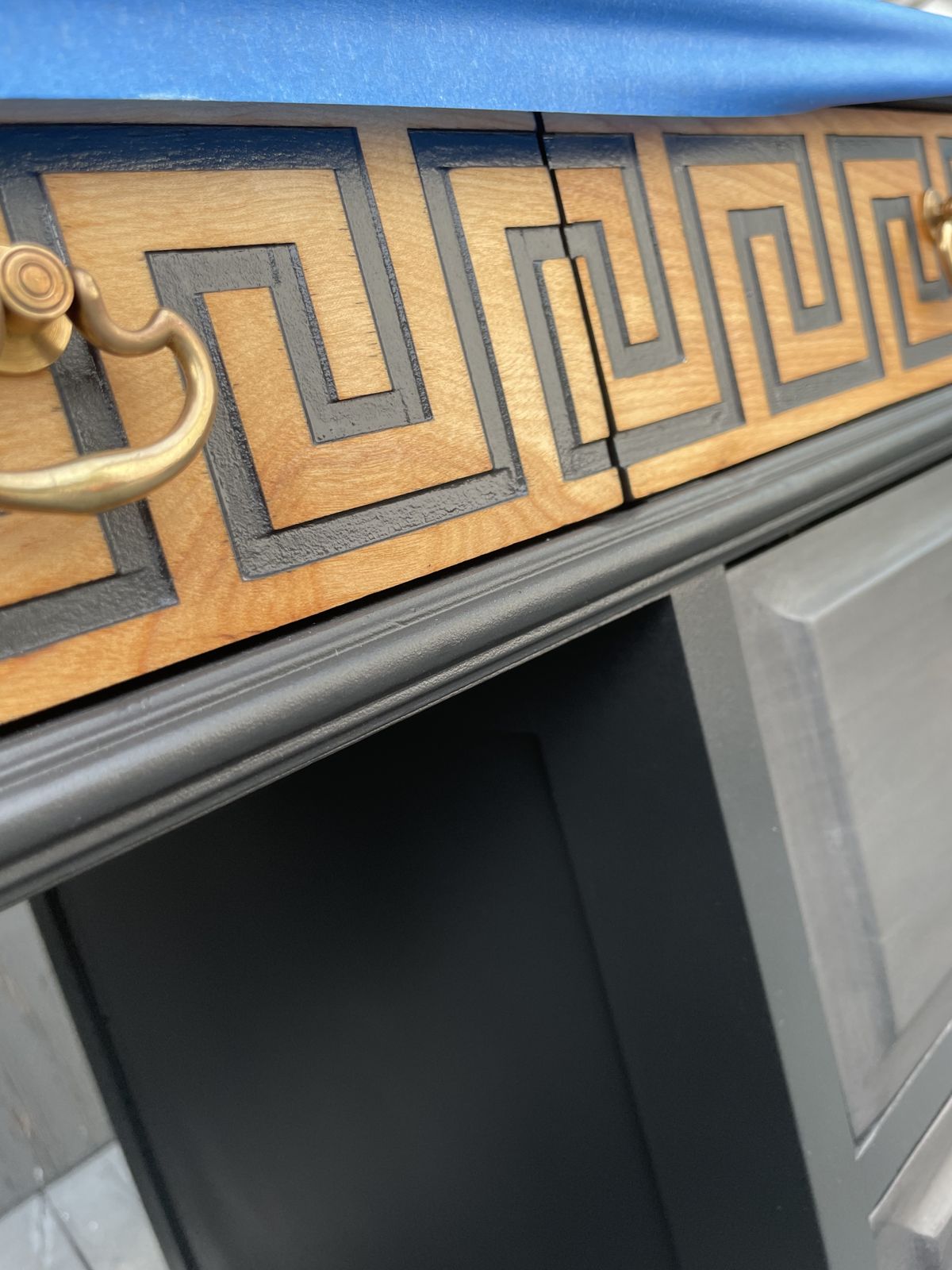 Close-up of the gold Greek key border detail