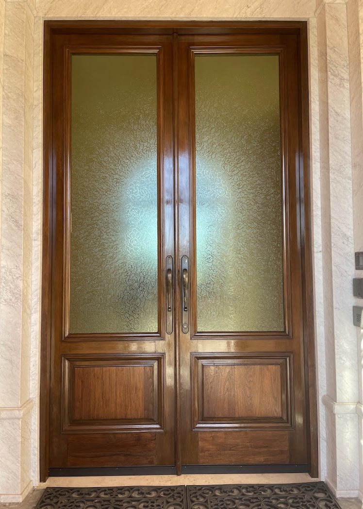 The same entry doors refinished to an even, deep tone