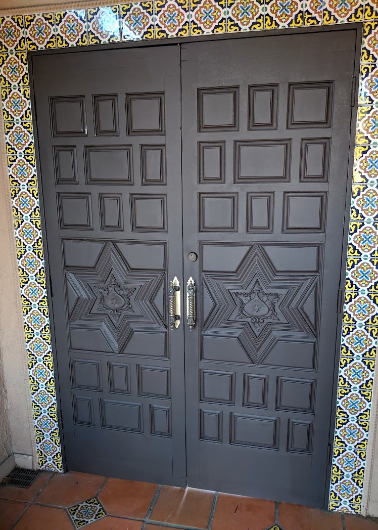 The same carved double door refinished in an even dark tone