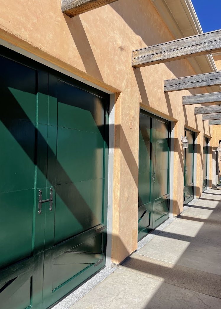 Finished green garage doors along the colonnade