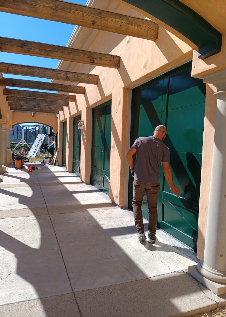 The run of finished garage doors seen down the walkway