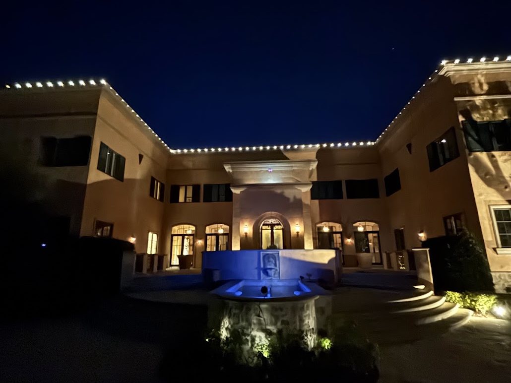 Front elevation and fountain court lit at night