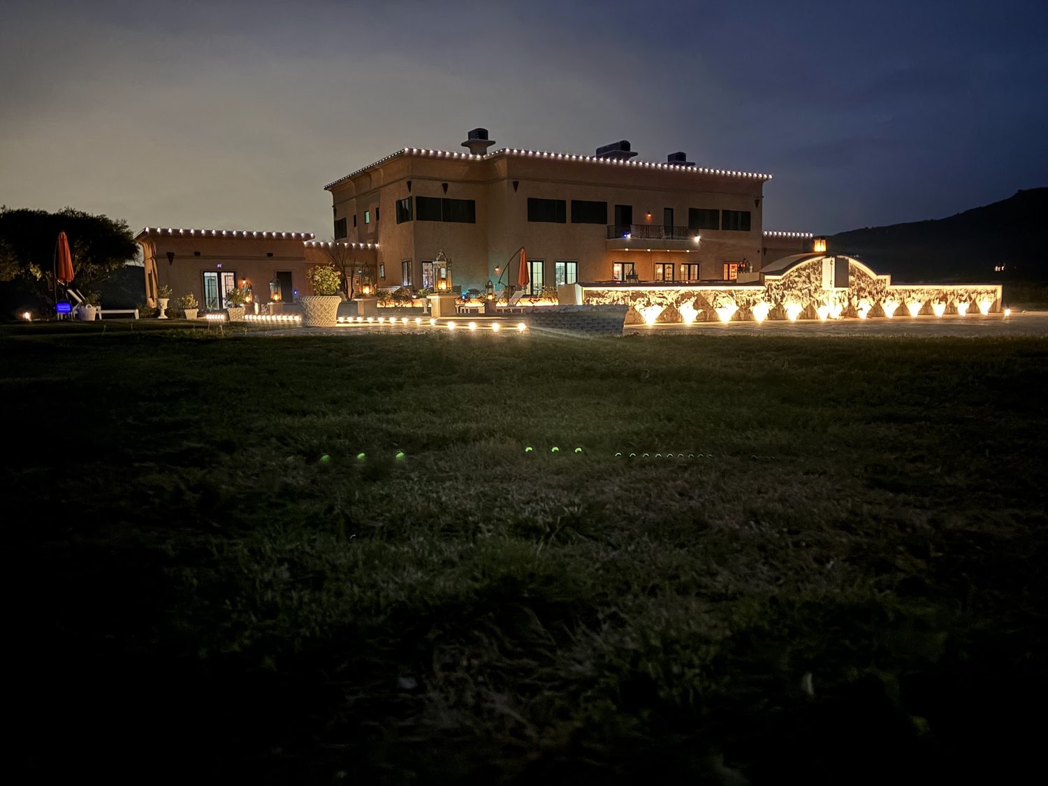 Wide view of the estate lit at night