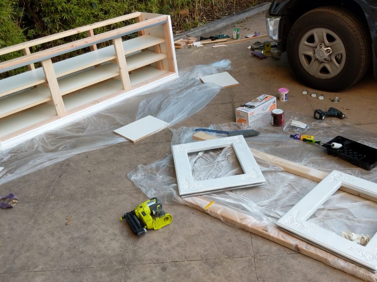 Painted panels and frames laid out on the ground